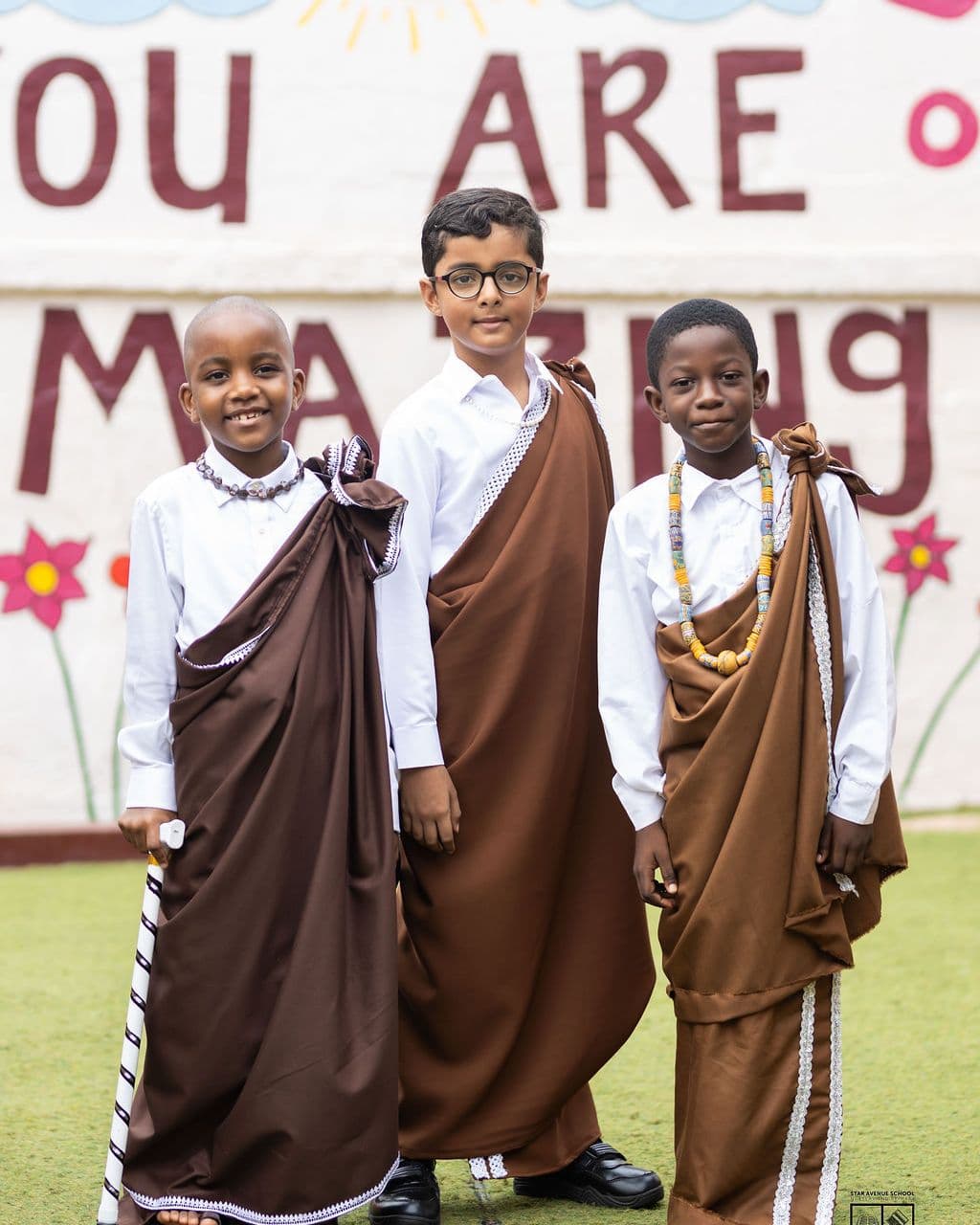 Three pupils in dress from across the continent