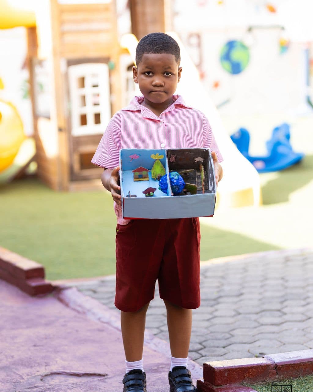 A pupil with his project by the playground