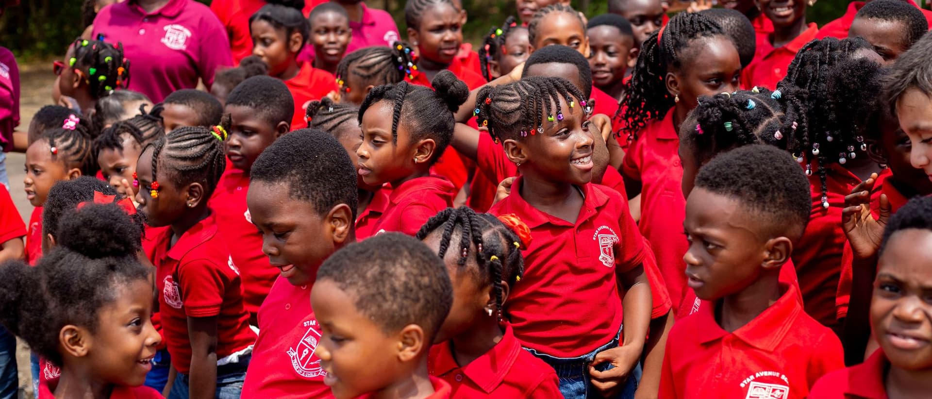 A crowd of Star Avenue pupils laughing together on a school outing