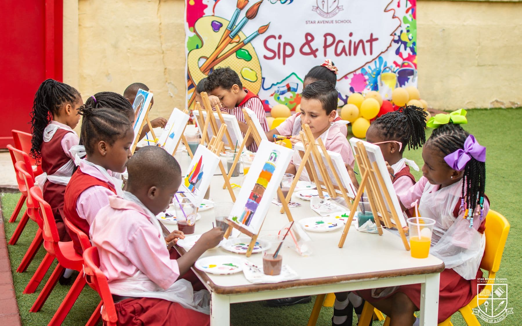 The Sip and Paint session in progress, a row of easels along the tables