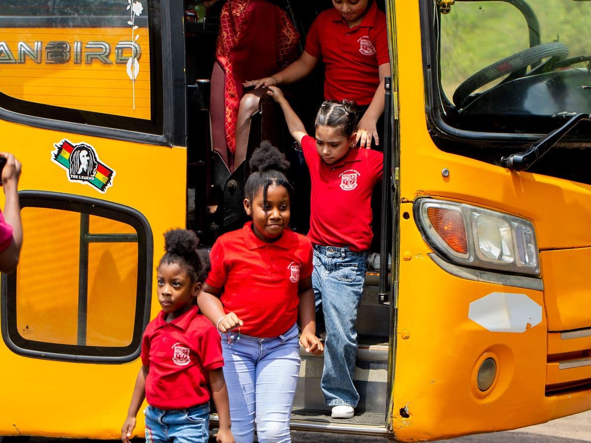 Pupils stepping down from the yellow school bus