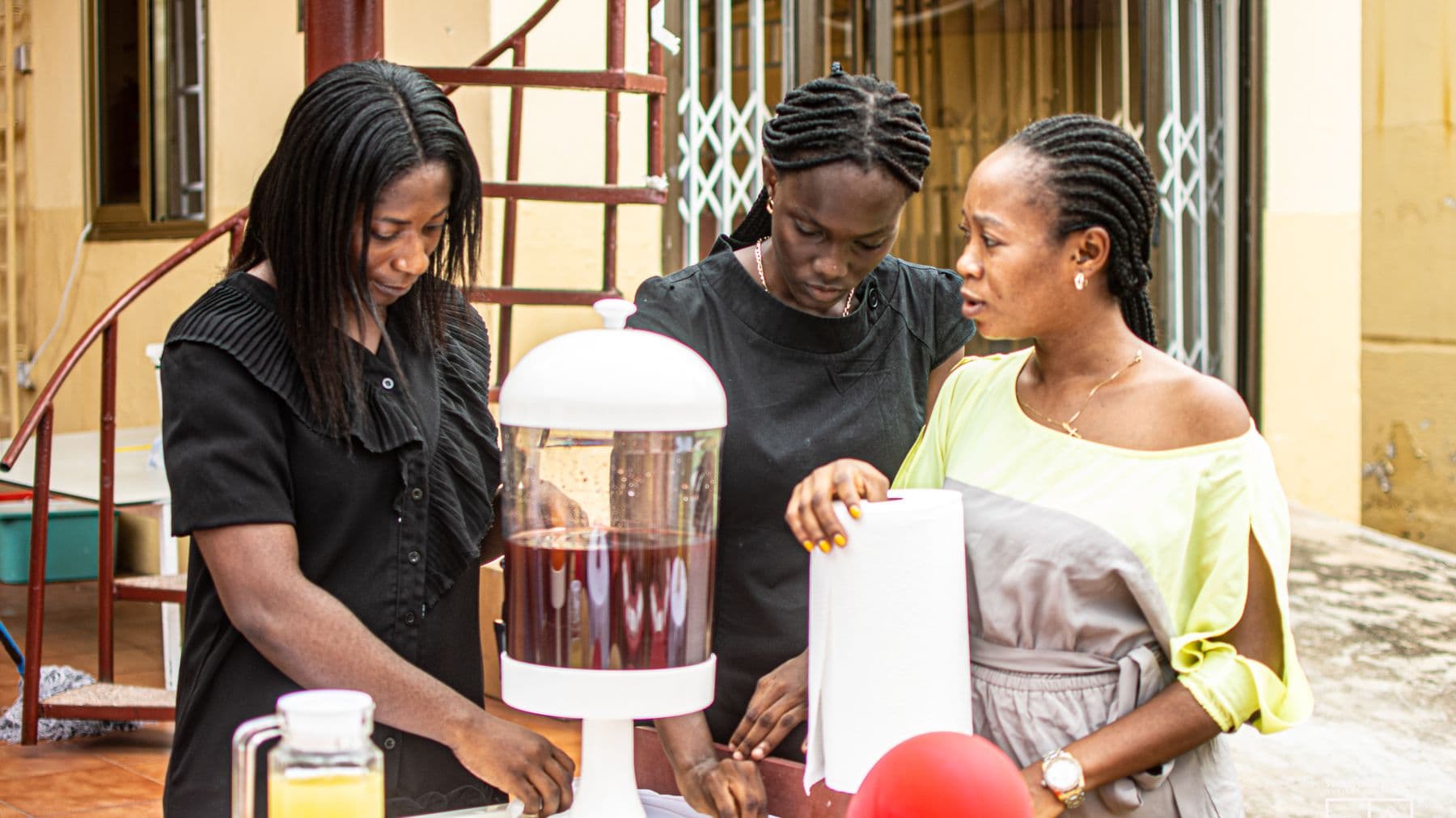 Members of staff setting up refreshments in the school courtyard before an event