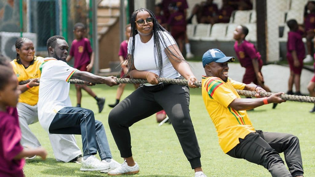 Pupils and staff pulling on the rope in the inter-house tug of war