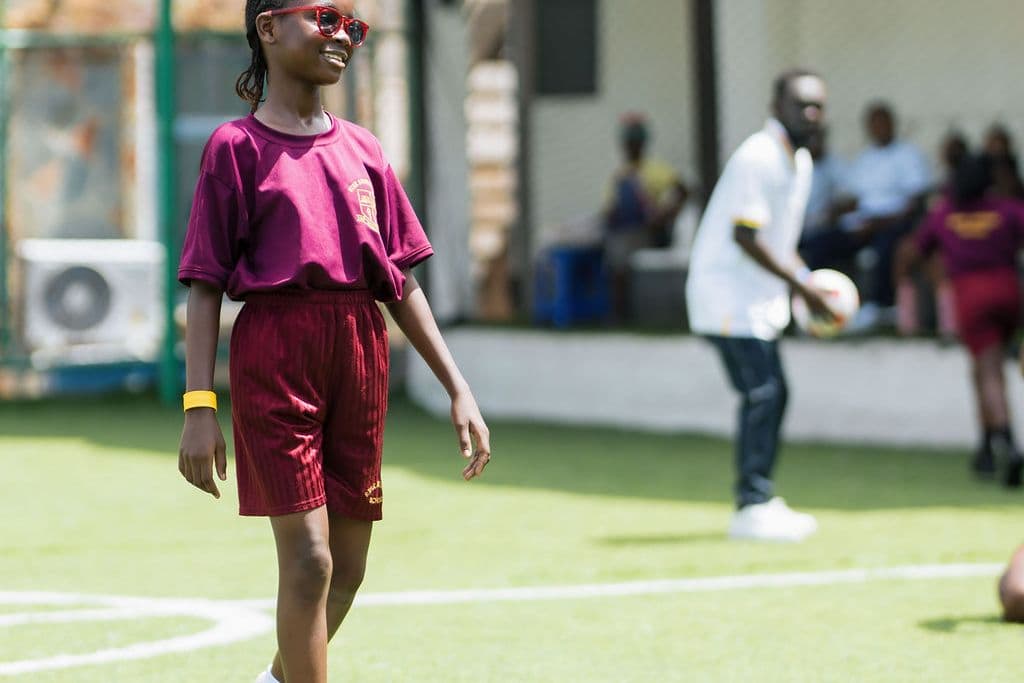 A pupil sprinting down the pitch on sports day